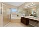 Well-lit bathroom featuring a glass shower, garden tub, and spacious vanity at 10097 Leland Dr, Orlando, FL 32827