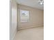 Neutral carpeted bedroom with ceiling fan, light walls, and a window with blinds at 10097 Leland Dr, Orlando, FL 32827
