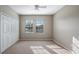 Well-lit bedroom with carpet floors and double closets at 10097 Leland Dr, Orlando, FL 32827