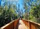 A wooden boardwalk surrounded by lush trees under a blue sky at 10097 Leland Dr, Orlando, FL 32827