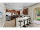 Bright kitchen featuring wood cabinets, stainless steel appliances, breakfast bar and wood-look flooring at 10097 Leland Dr, Orlando, FL 32827