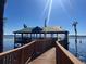 Wooden walkway to a lakeside gazebo at 10097 Leland Dr, Orlando, FL 32827