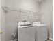 Laundry area with modern washer and dryer, and wire shelving for storage and organization at 10097 Leland Dr, Orlando, FL 32827