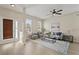 Bright living room with wood floors, neutral walls, lots of light, and comfortable seating at 10097 Leland Dr, Orlando, FL 32827