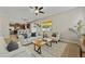 Bright living room open to the kitchen featuring wood-look flooring, neutral paint and plenty of natural light at 10097 Leland Dr, Orlando, FL 32827