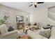 Cozy living room with wood-look flooring, neutral paint, furniture, decor and plenty of natural light at 10097 Leland Dr, Orlando, FL 32827