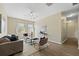 Modern living room featuring wood-look flooring, neutral decor, and ample natural light at 10097 Leland Dr, Orlando, FL 32827