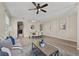 Open-concept living and dining area with modern decor, wood floors, and plenty of space for entertaining at 10097 Leland Dr, Orlando, FL 32827