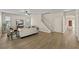 Inviting living room with wood-look flooring, neutral paint, staircase and an abundance of natural light at 10097 Leland Dr, Orlando, FL 32827