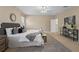 Spacious main bedroom featuring a ceiling fan, neutral decor, and a decorative rug at 10097 Leland Dr, Orlando, FL 32827