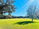 Green park with lush grass and mature trees at 10097 Leland Dr, Orlando, FL 32827