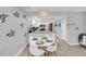 Bright dining area with a round table and four white chairs at 111 N Atlantic Ave # 2090, New Smyrna Beach, FL 32169