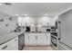 White cabinets, granite countertops, and stainless steel appliances at 111 N Atlantic Ave # 2090, New Smyrna Beach, FL 32169