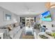 Bright living room with comfy seating, large TV, and adjacent dining area at 111 N Atlantic Ave # 2090, New Smyrna Beach, FL 32169
