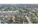 Aerial view of a residential neighborhood with a community lake at 11944 Cheltinham Dr, Orlando, FL 32824