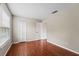 Bedroom with wood floors, window, and closet at 11944 Cheltinham Dr, Orlando, FL 32824