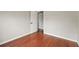 Simple bedroom with wood floors and an interior door at 11944 Cheltinham Dr, Orlando, FL 32824