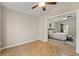 Spacious bedroom with wood floors and access to another room at 11944 Cheltinham Dr, Orlando, FL 32824