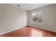 Bright bedroom with wood floors and a large window at 11944 Cheltinham Dr, Orlando, FL 32824