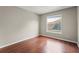 Bright bedroom with wood floors and large window at 11944 Cheltinham Dr, Orlando, FL 32824