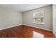 Bedroom with wood floors and a window with blinds at 11944 Cheltinham Dr, Orlando, FL 32824
