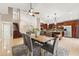 Kitchen and dining area with hardwood floors, a large island and modern lighting fixtures at 11944 Cheltinham Dr, Orlando, FL 32824