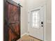 Entryway with barn door and glass-paned door at 11944 Cheltinham Dr, Orlando, FL 32824