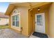Front entrance with white door and sidelights at 11944 Cheltinham Dr, Orlando, FL 32824