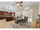 Modern kitchen with dark wood cabinetry, granite counters, and an island with seating at 11944 Cheltinham Dr, Orlando, FL 32824