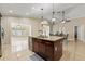 Modern kitchen island with wine cooler and breakfast bar at 11944 Cheltinham Dr, Orlando, FL 32824