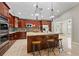 Island kitchen with granite countertops and stainless steel appliances at 11944 Cheltinham Dr, Orlando, FL 32824