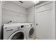 Laundry room with washer, dryer, and shelving at 11944 Cheltinham Dr, Orlando, FL 32824