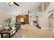 Open concept living area showcasing a stylish wood accent wall and adjacent dining space at 11944 Cheltinham Dr, Orlando, FL 32824