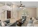Bright living room featuring vaulted ceilings and a cozy seating area at 11944 Cheltinham Dr, Orlando, FL 32824