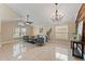 Living room with vaulted ceiling, large windows, and decorative wall at 11944 Cheltinham Dr, Orlando, FL 32824