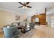 Living room with vaulted ceiling, wood accent wall, and comfy seating at 11944 Cheltinham Dr, Orlando, FL 32824
