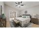 Main bedroom with ceiling fan and ensuite bathroom access at 11944 Cheltinham Dr, Orlando, FL 32824