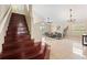 Elegant hardwood staircase leading to the upper level of the home at 11944 Cheltinham Dr, Orlando, FL 32824