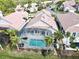 House with screened pool and backyard, surrounded by other homes at 13328 Lake Turnberry Cir, Orlando, FL 32828
