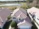 Two-story house with a lake view and Spanish tile roof at 13328 Lake Turnberry Cir, Orlando, FL 32828