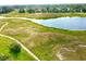 Community view with a lake and various houses at 13328 Lake Turnberry Cir, Orlando, FL 32828