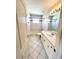Clean bathroom with a tub, vanity, and tiled floors at 13328 Lake Turnberry Cir, Orlando, FL 32828