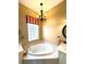 Bathroom with a large jetted tub and updated fixtures at 13328 Lake Turnberry Cir, Orlando, FL 32828