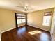 Bright bedroom featuring hardwood floors and dual windows at 13328 Lake Turnberry Cir, Orlando, FL 32828