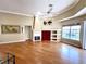 Bright living room with hardwood floors, fireplace, and large windows at 13328 Lake Turnberry Cir, Orlando, FL 32828