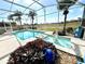 Inviting screened pool with a fountain and tropical plants at 13328 Lake Turnberry Cir, Orlando, FL 32828