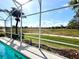 Screened pool with a view of the open green space at 13328 Lake Turnberry Cir, Orlando, FL 32828