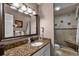 Bathroom featuring granite countertop, large mirror and shower at 1339 Villa Ln # 50, Apopka, FL 32712