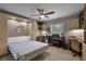 Bedroom with a Murphy bed, built-in workspace and ceiling fan at 1339 Villa Ln # 50, Apopka, FL 32712
