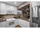 Updated kitchen with white cabinets, granite countertops, and stainless steel appliances at 1339 Villa Ln # 50, Apopka, FL 32712